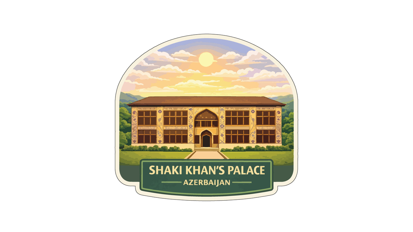 a large, multi-story building with a brown roof and multiple windows, set against a backdrop of a sunset sky with clouds.