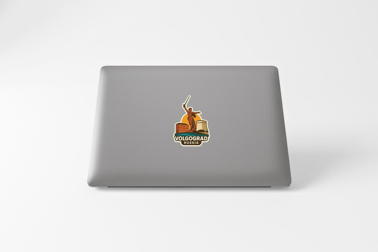 a sticker with a graphic of a person holding a flag, placed on the back of a laptop computer.