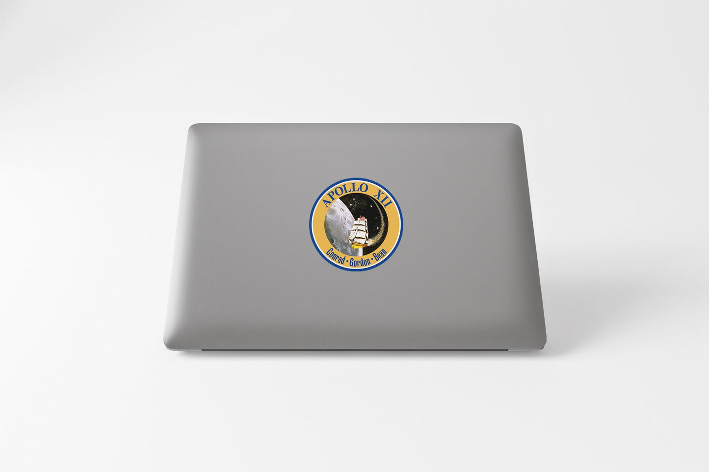 a laptop with a sticker of a man holding a gun