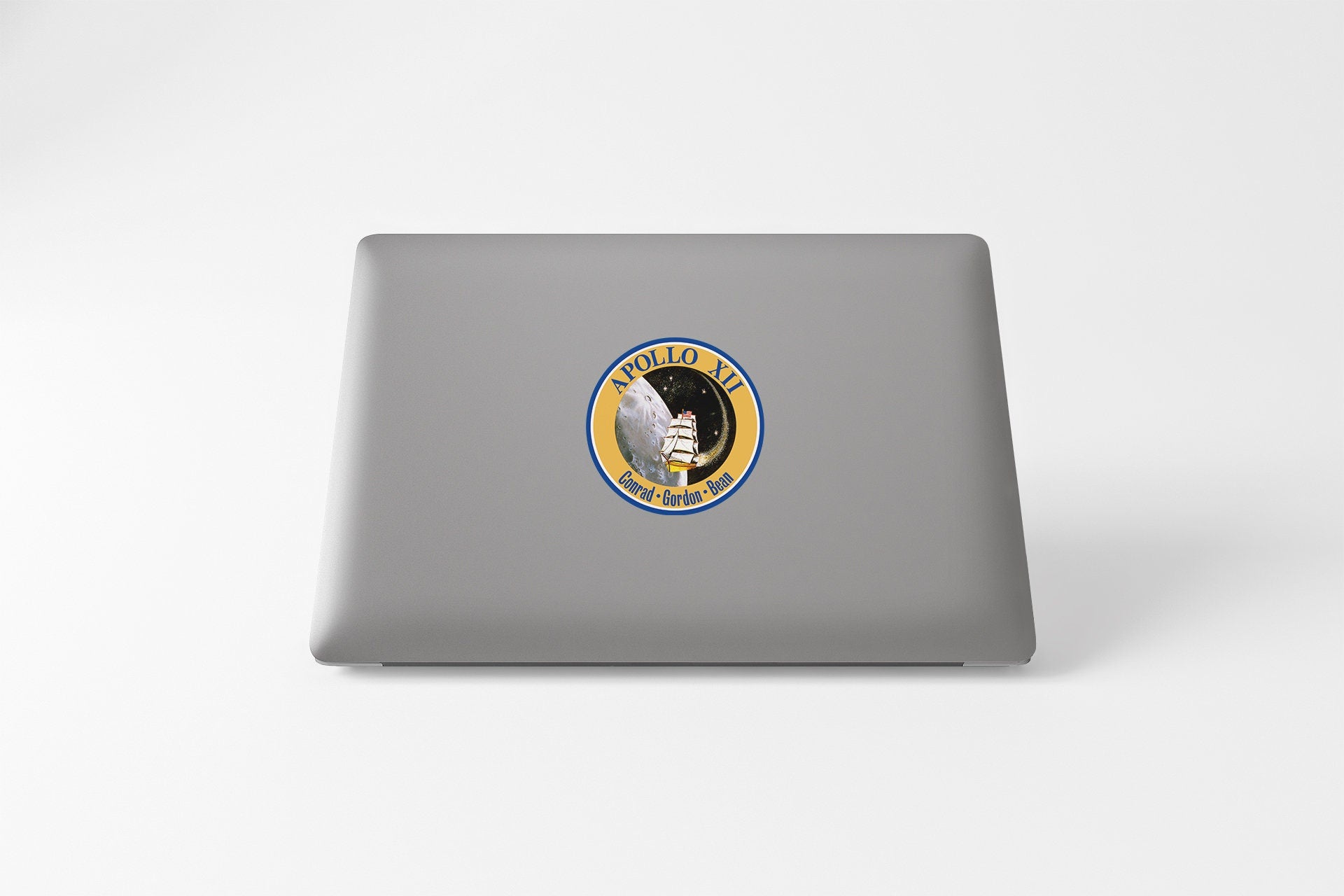 a laptop with a sticker of a man holding a gun