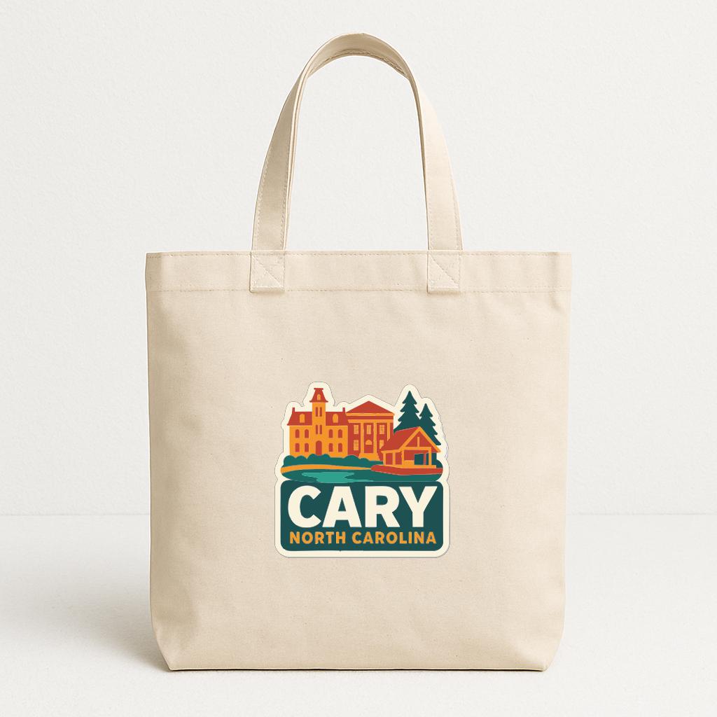 A beige tote bag with a graphic design featuring a building and trees, along with the text "CARY NORTH CAROLINA".