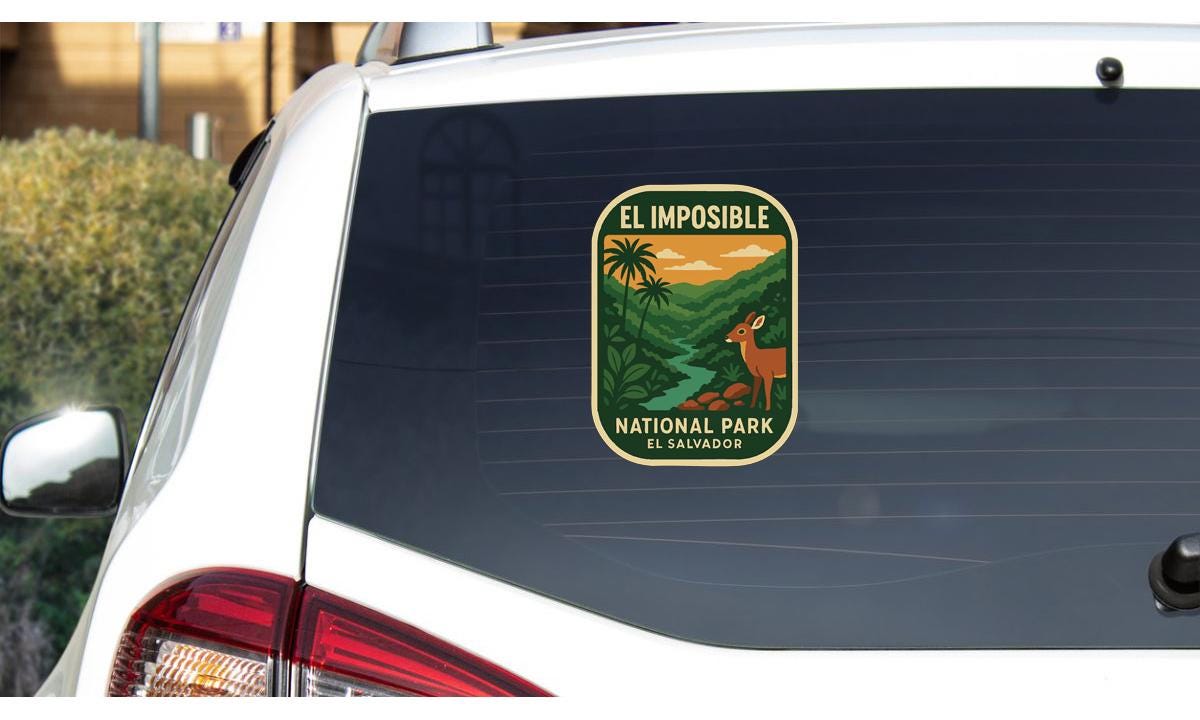 a sticker on the rear window of a car, depicting a scenic landscape with a deer and palm trees.