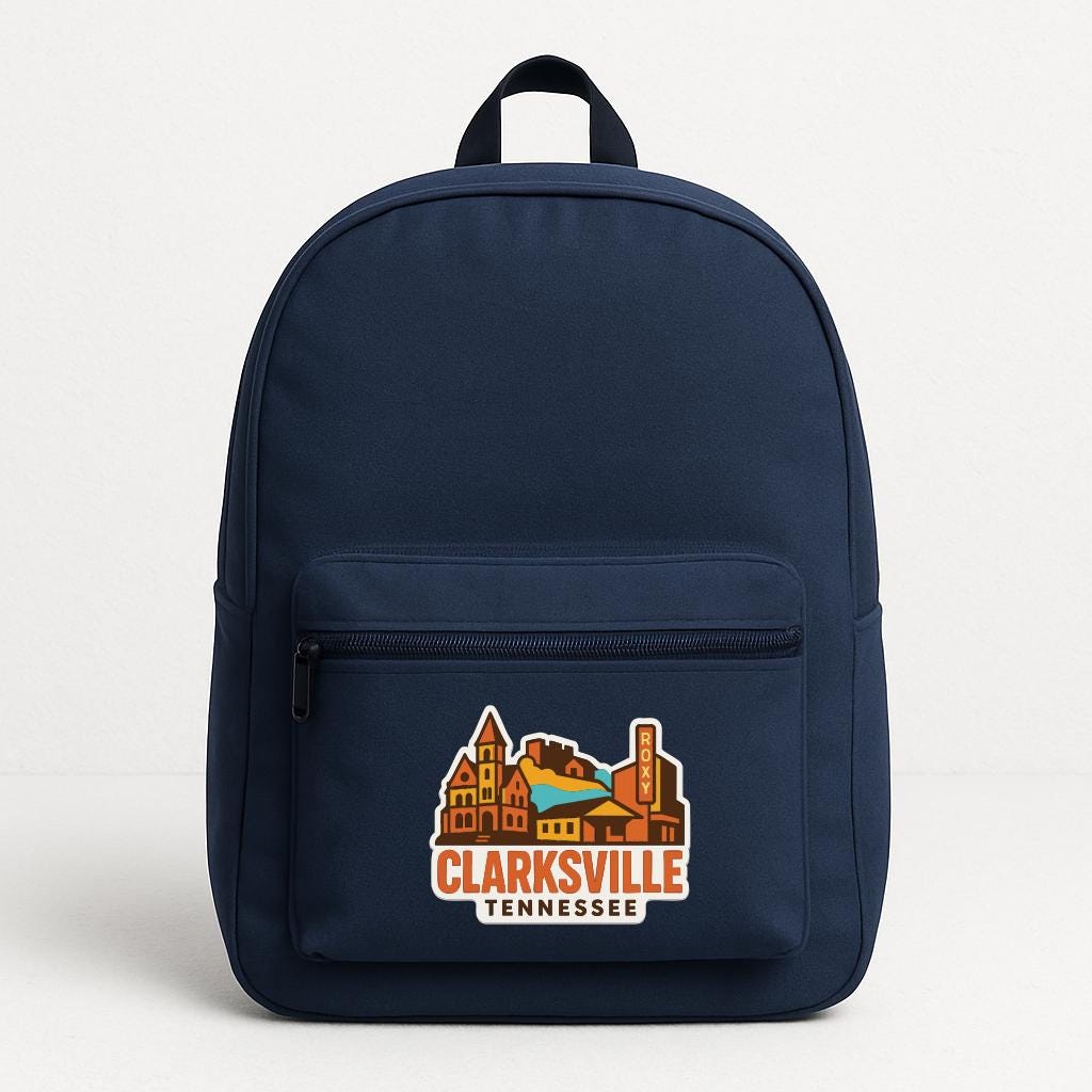 A navy blue backpack with a graphic of a city and the text "CLARKSVILLE TENNESSEE" printed on it.