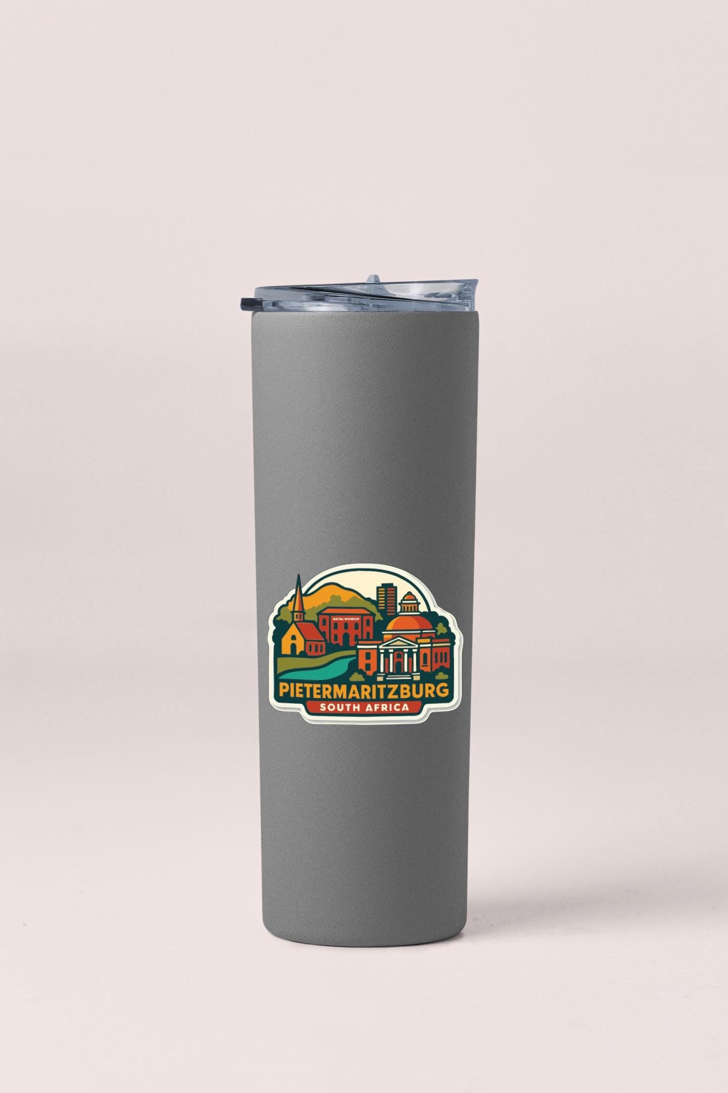 A gray insulated tumbler with a colorful sticker depicting a cityscape and the text "Pietermaritzburg SOUTH AFRICA".