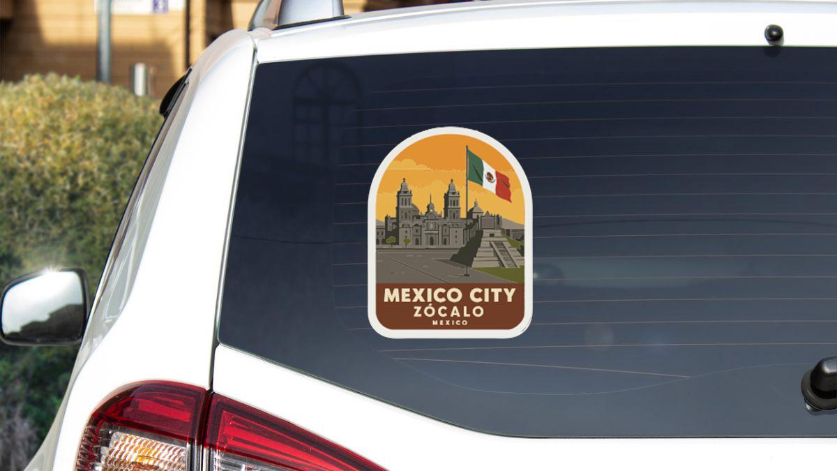 A sticker on the rear window of a car, depicting the city of Mexico City, with the text "MEXICO CITY ZOCALO MEXICO" printed on it.