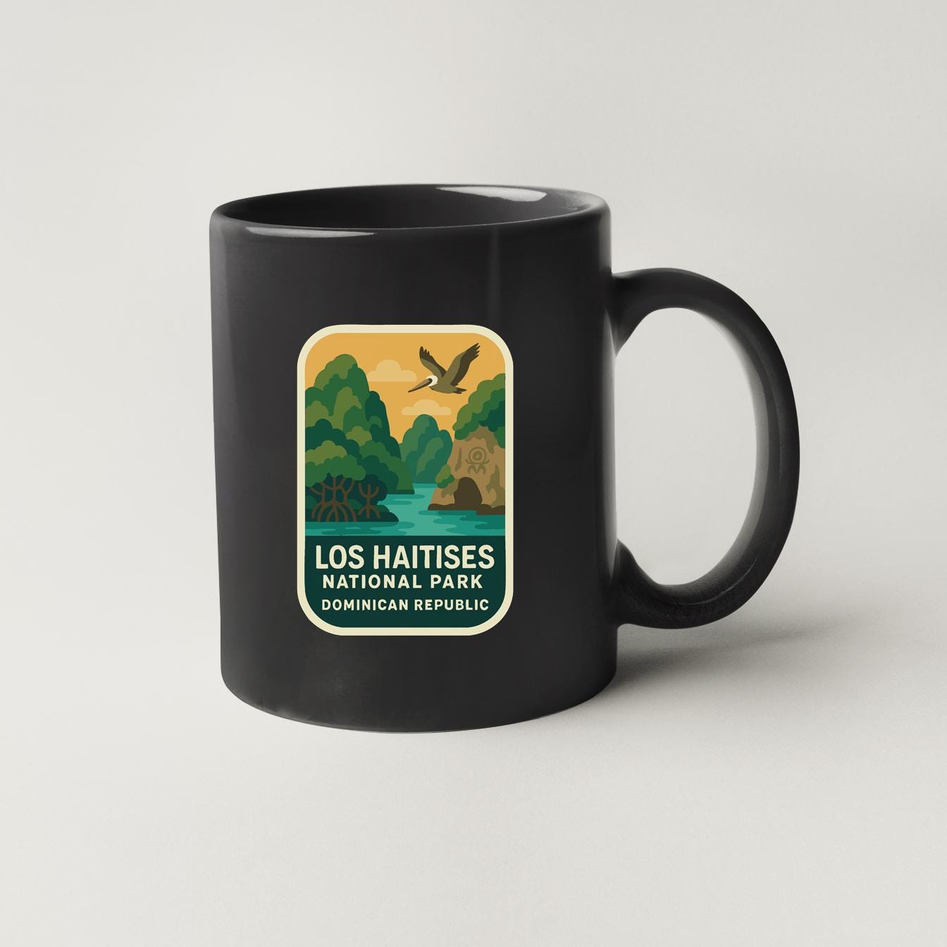 A black coffee mug with a label that says "LOS HAITISES NATIONAL PARK DOMINICAN REPUBLIC".