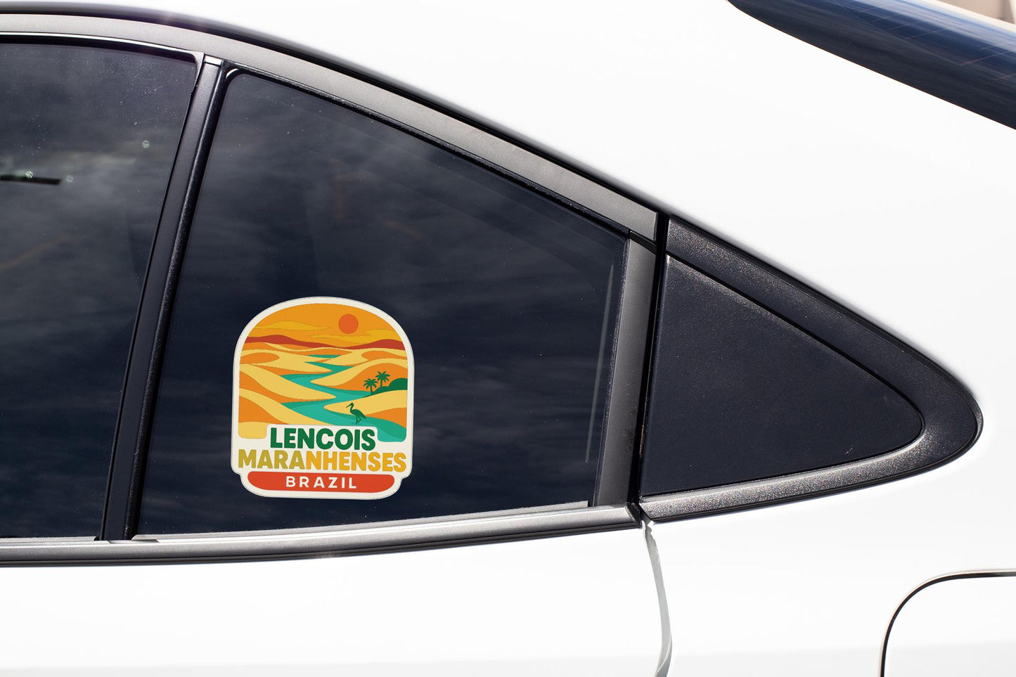 A sticker on the side of a car window, featuring a landscape with palm trees and a sunset.