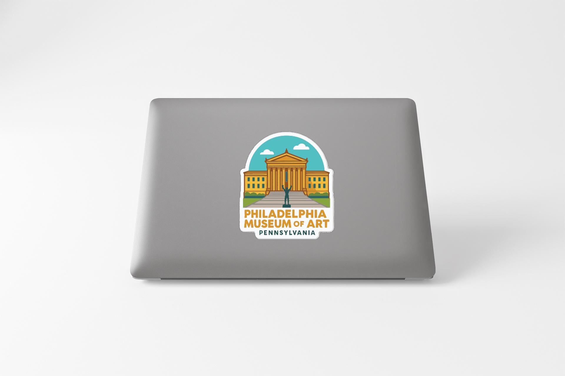 a sticker or decal of the Philadelphia Museum of Art on the back of a laptop computer.