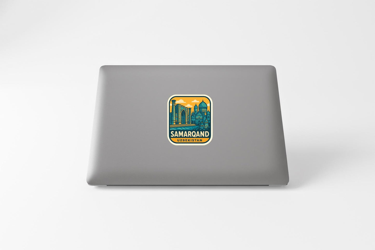 a sticker with a cityscape and the text "SAMAROJAN" on a laptop.