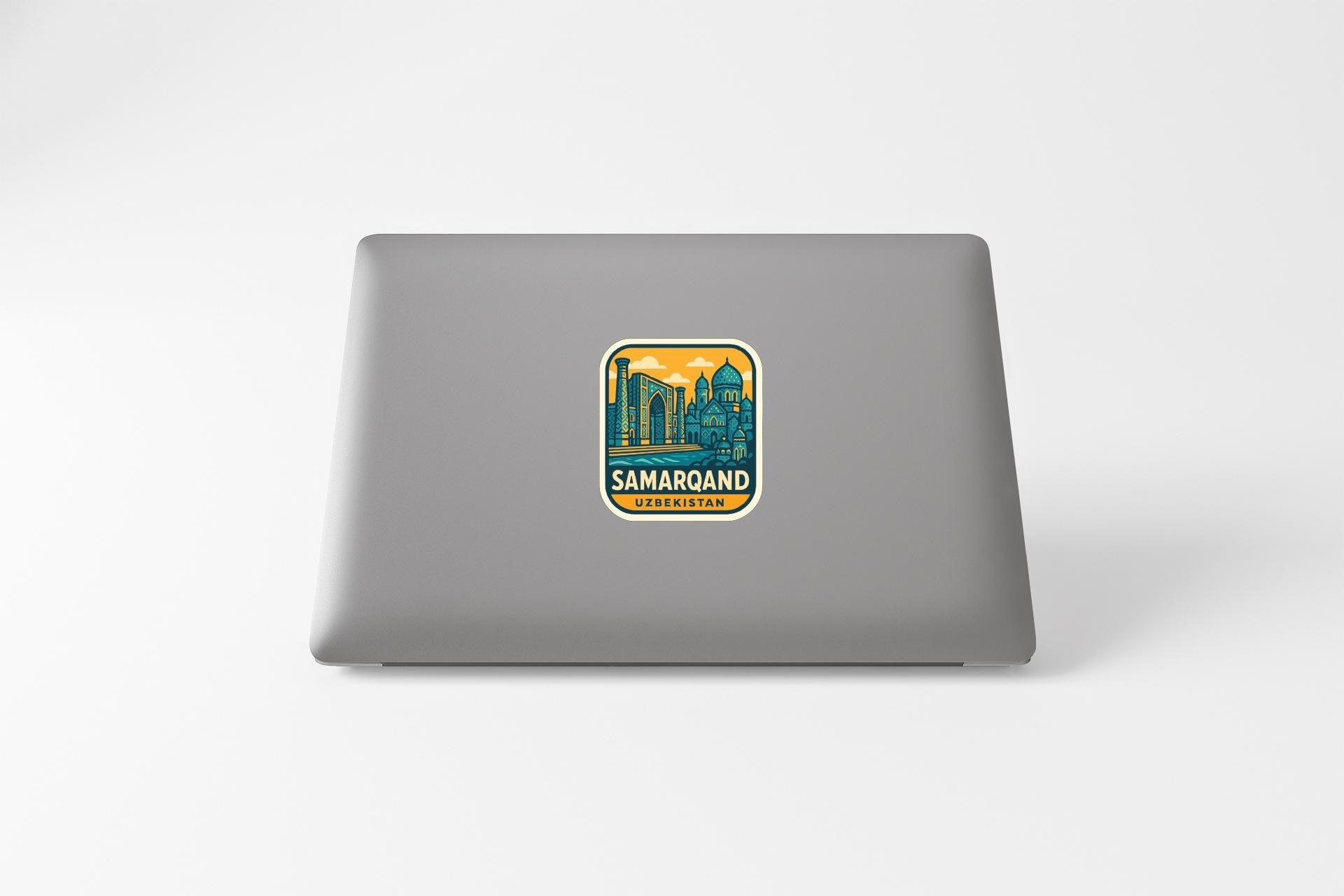 a sticker with a cityscape and the text "SAMAROJAN" on a laptop.