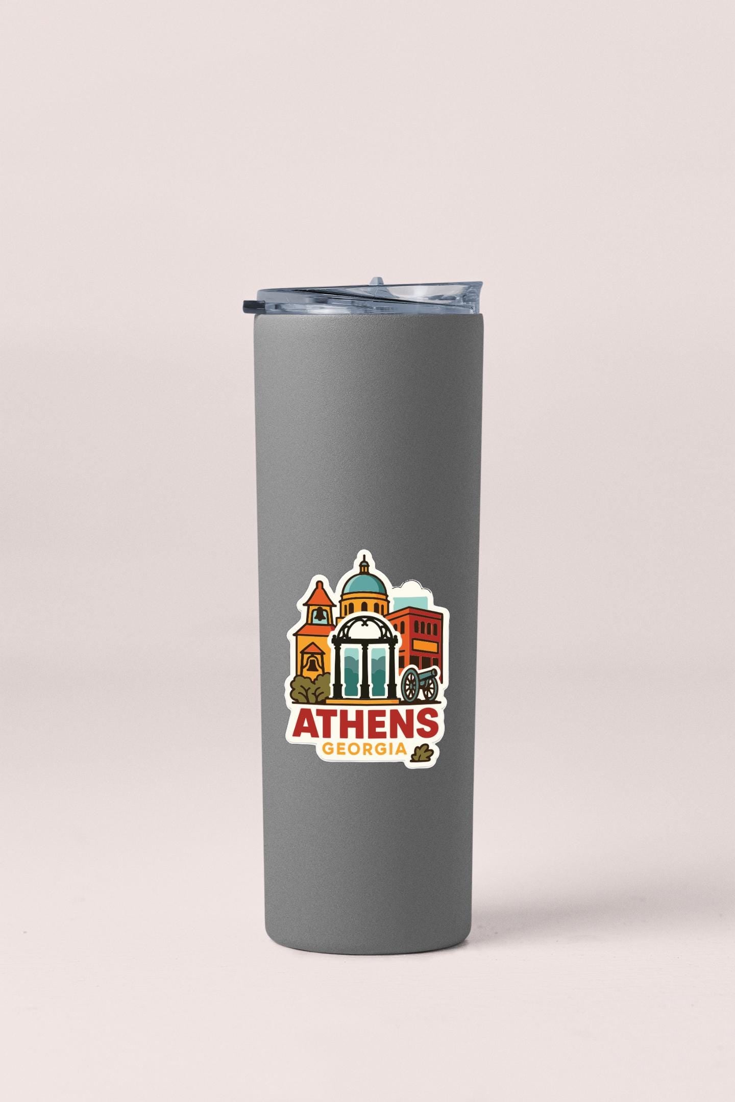 A gray insulated tumbler with a lid and a sticker featuring the city of Athens, Georgia.