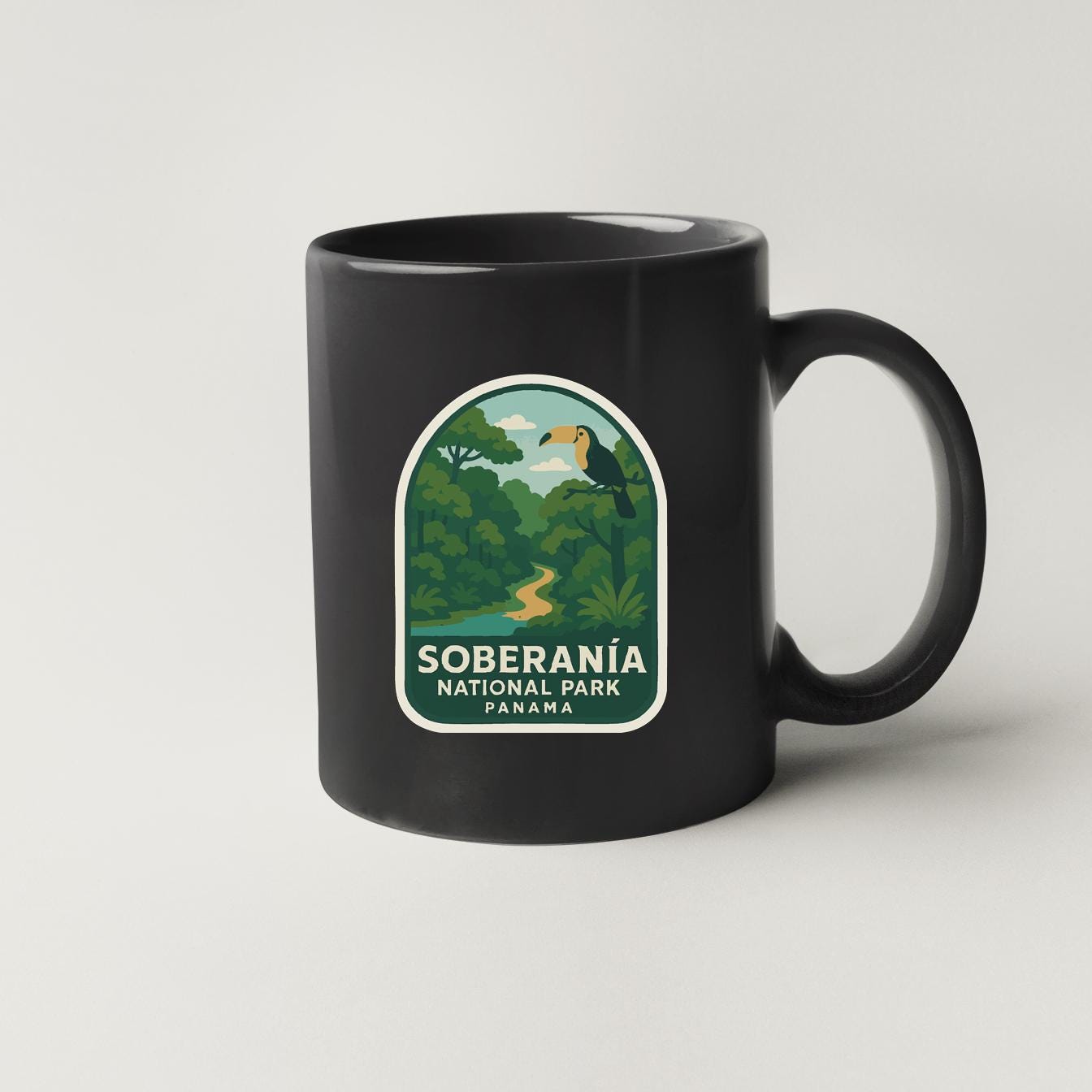 A black coffee mug with a label that says "Soberánía National Park Panama".