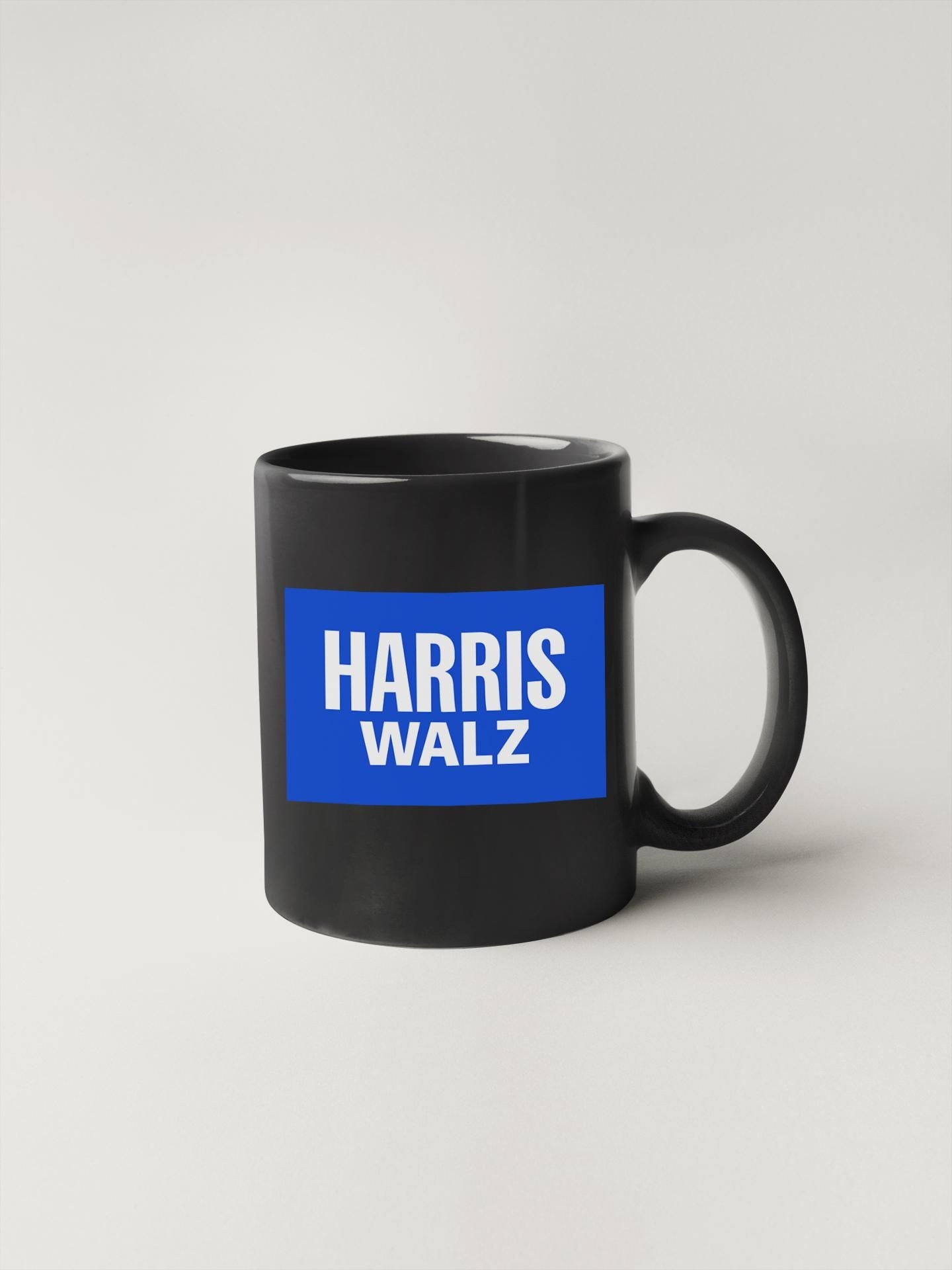 a black and blue coffee mug with the words harris walz on it