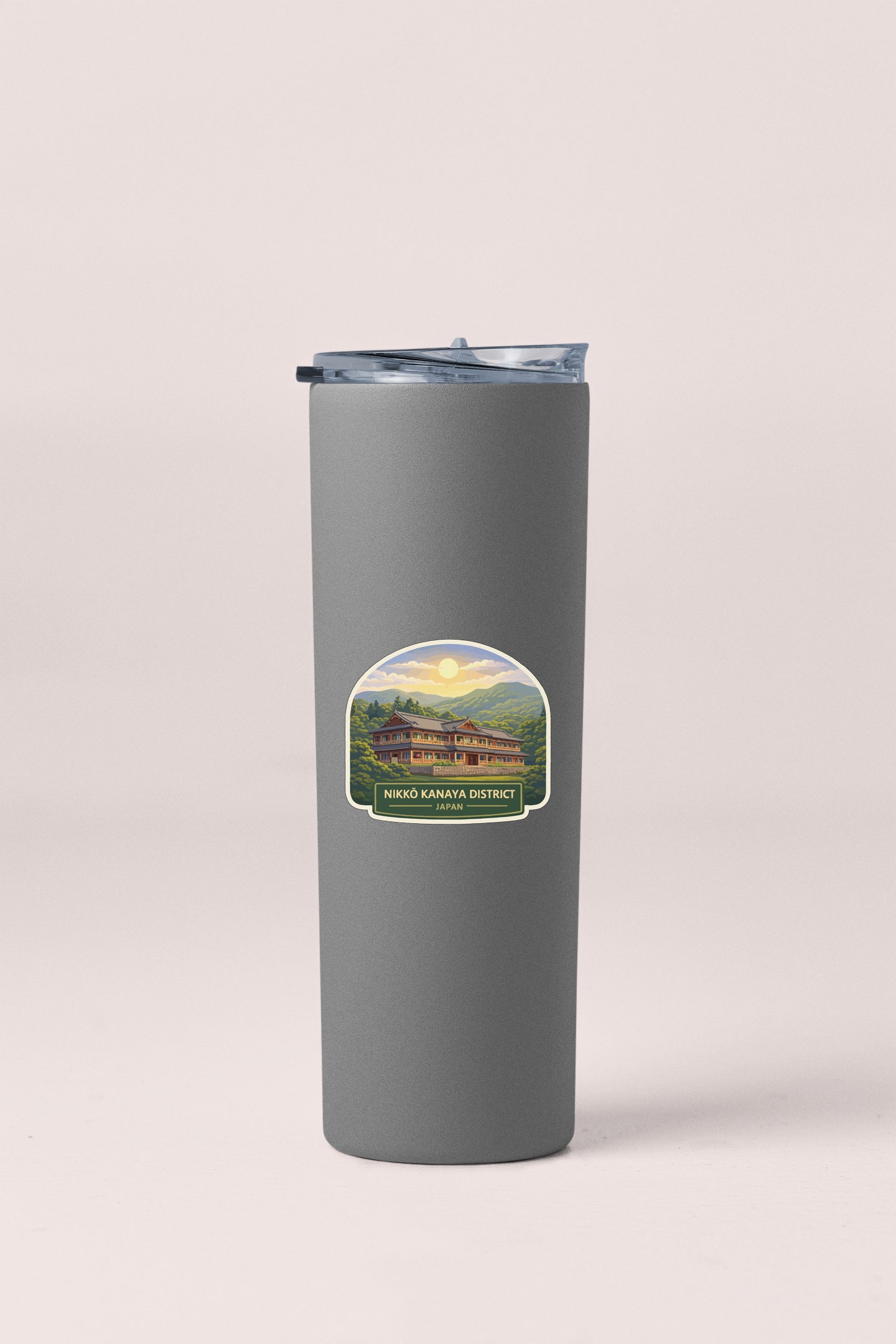 A gray insulated tumbler with a label featuring a scenic landscape.