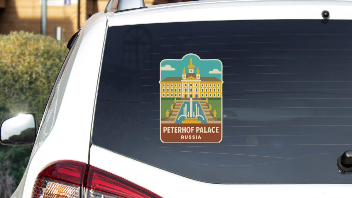 A sticker on the rear window of a car, depicting the Peterhof Palace in Russia.