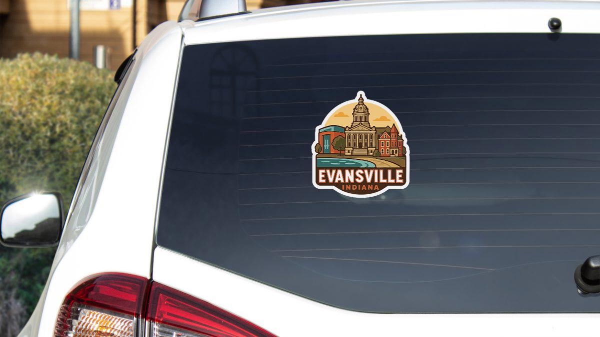 A sticker on the rear window of a white vehicle, depicting a cityscape with a prominent building.