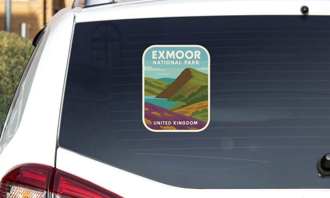 a sticker on the rear window of a car that says "Exmoor National Park" and "United Kingdom".