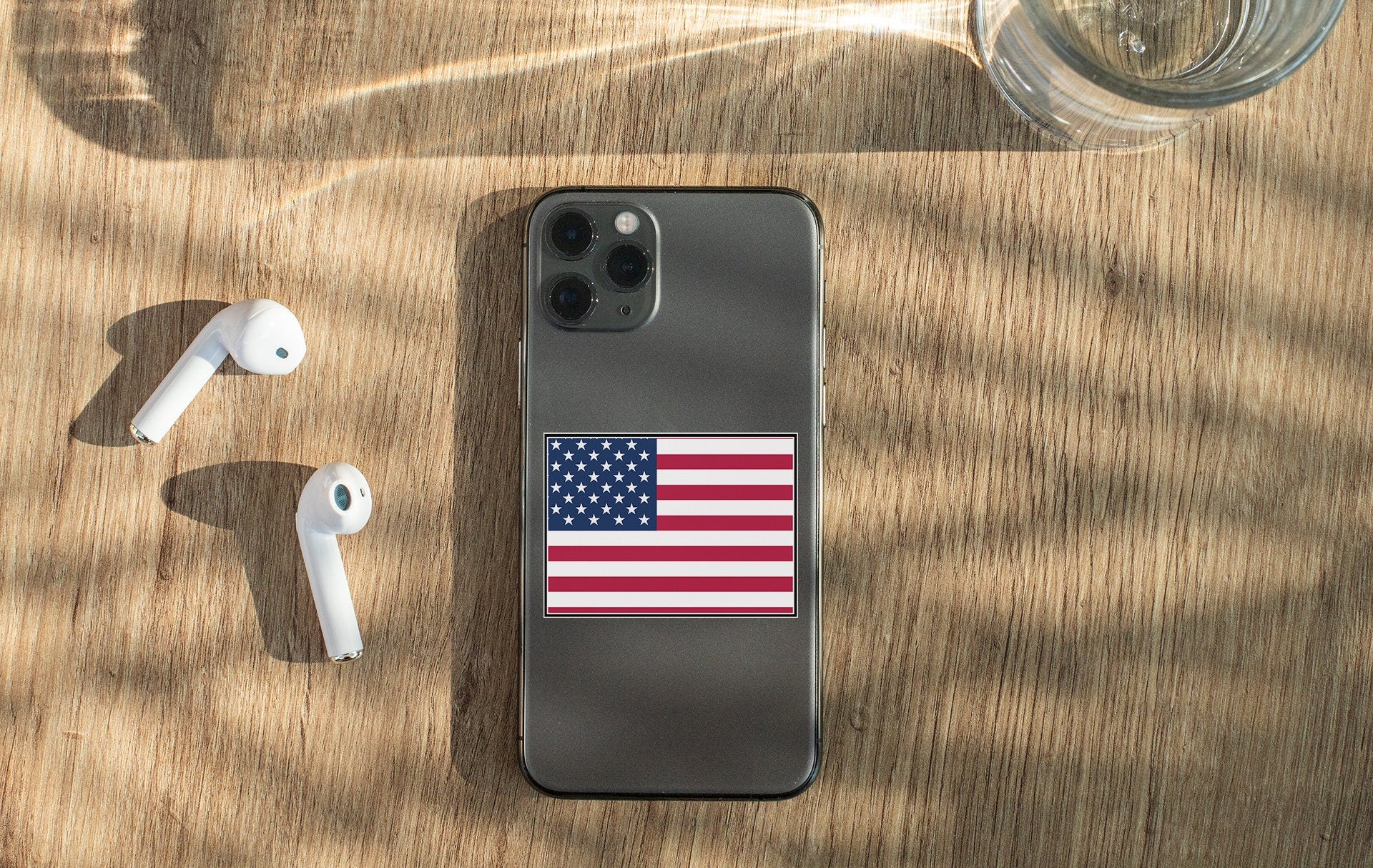 an iphone case with an american flag sticker on it