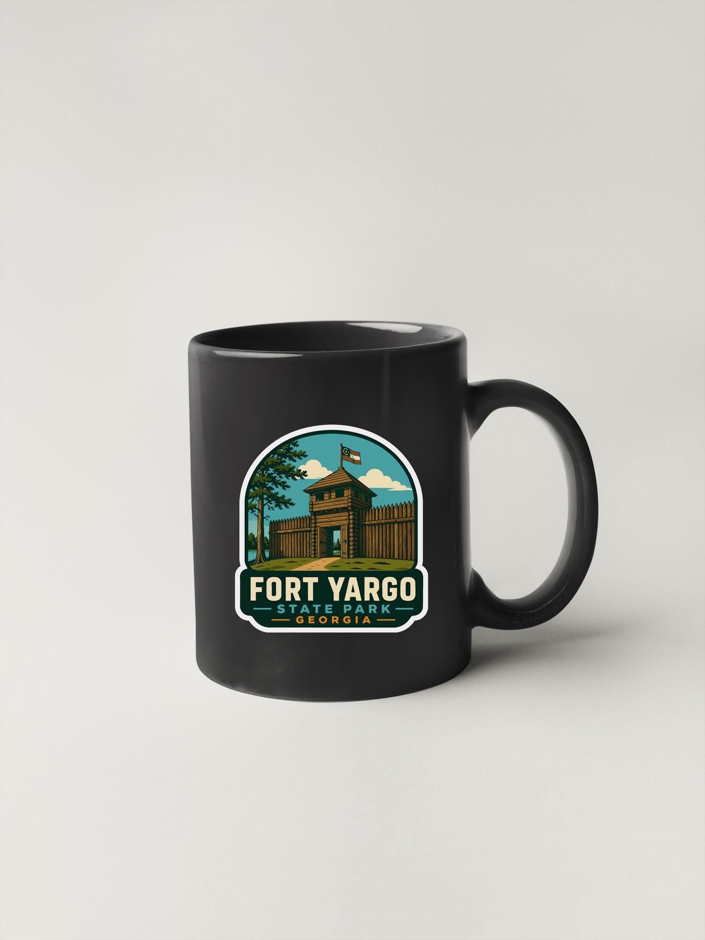 A black coffee mug with a graphic design depicting Fort Yargo, a historic landmark in Georgia.