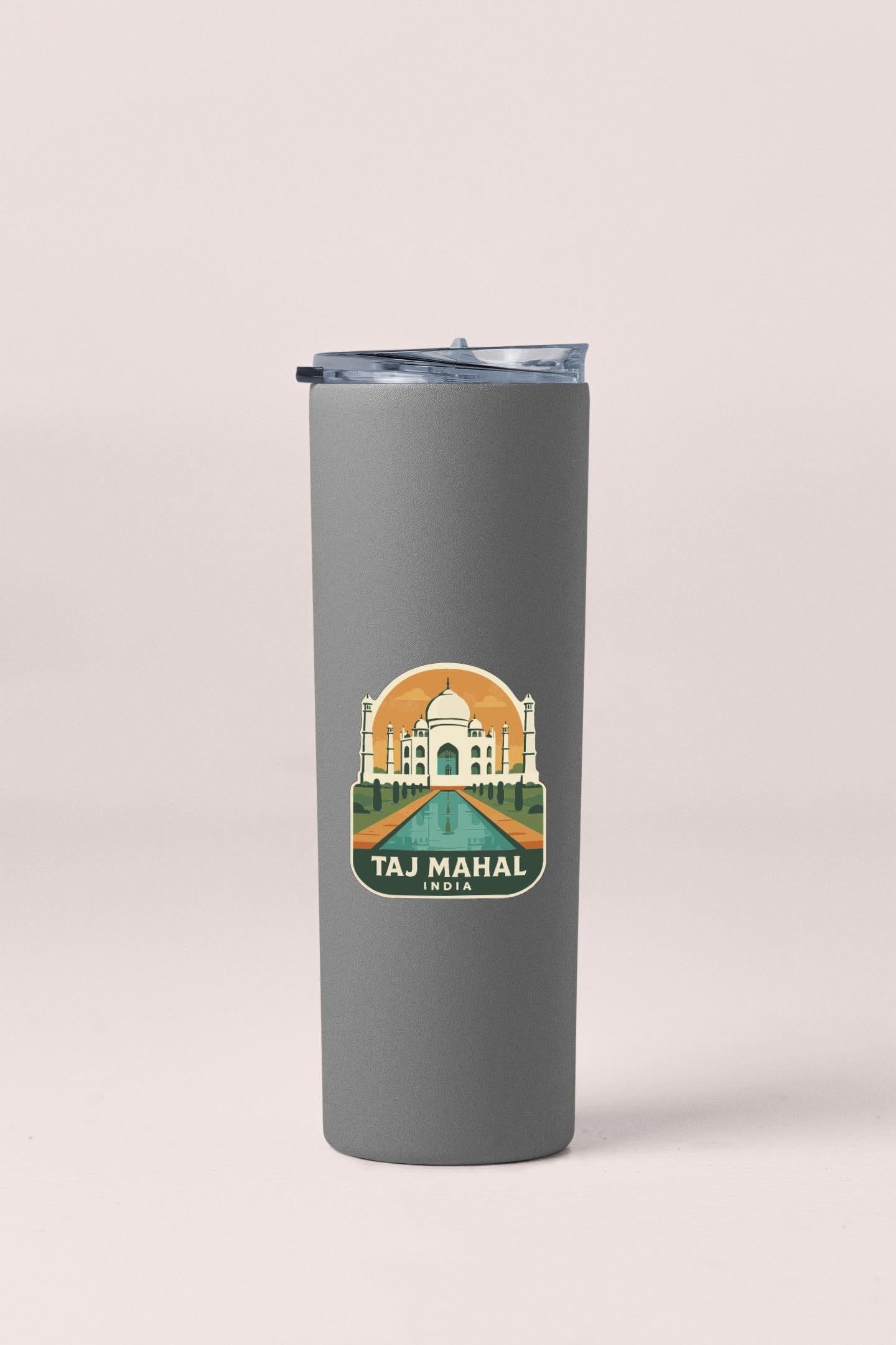 A gray insulated tumbler with a sticker depicting the Taj Mahal in India.
