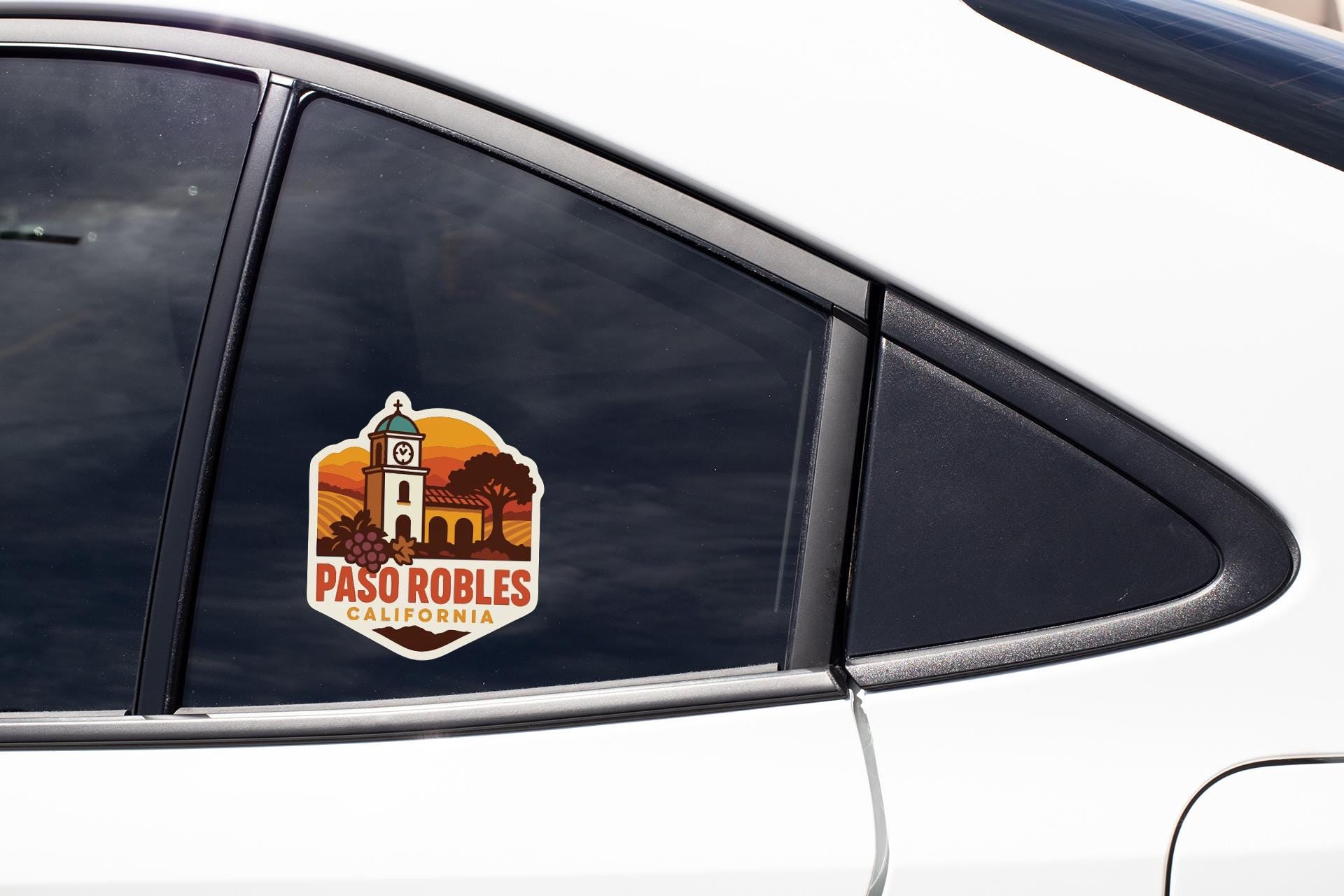 A sticker on the side of a car window, featuring a graphic of a building and the text "PASO ROBLES CALIFORNIA".