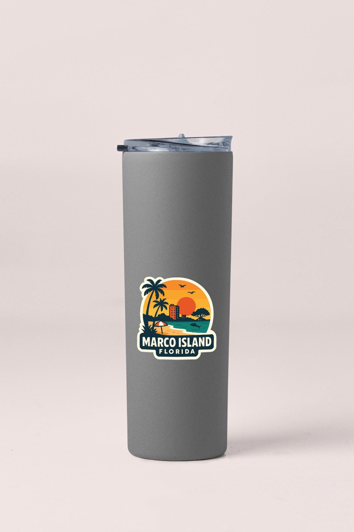 A gray insulated tumbler with a printed sticker depicting a tropical beach scene and palm trees.