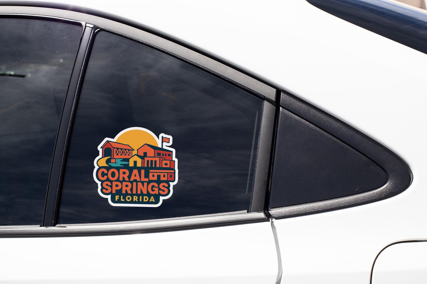 A sticker on the side of a car window, featuring a colorful illustration of a building and the text "Coral Springs, Florida".