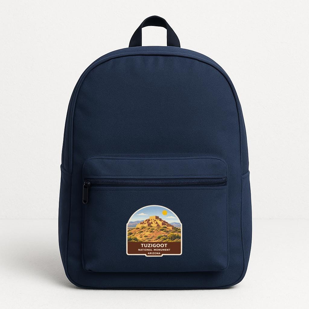 A navy blue backpack with a label that says "TUZIGOOT NATURE PARK ARIZONA" on the front pocket area.