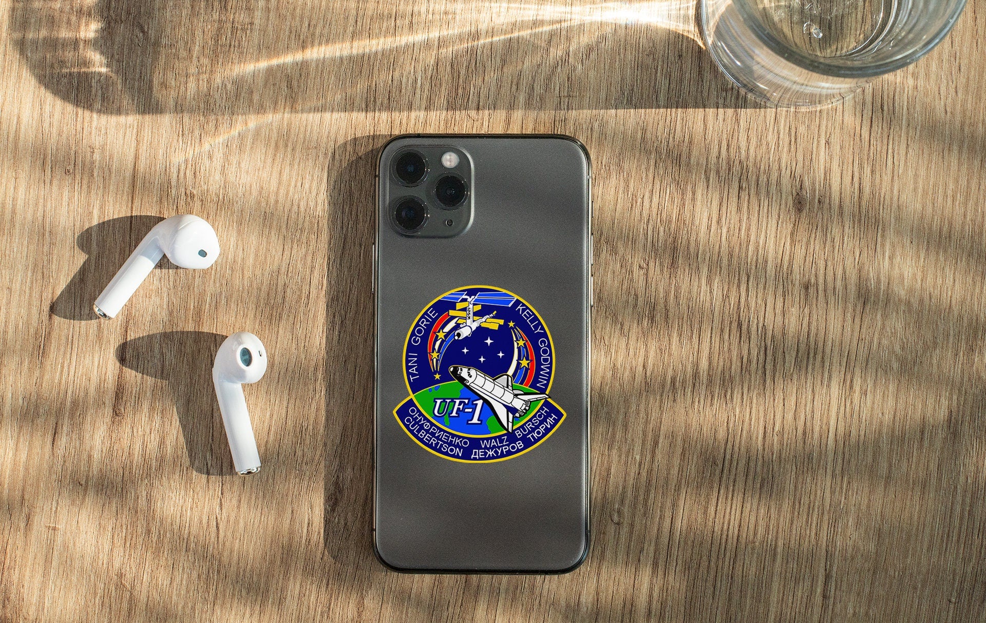 a phone and ear buds sitting on a table