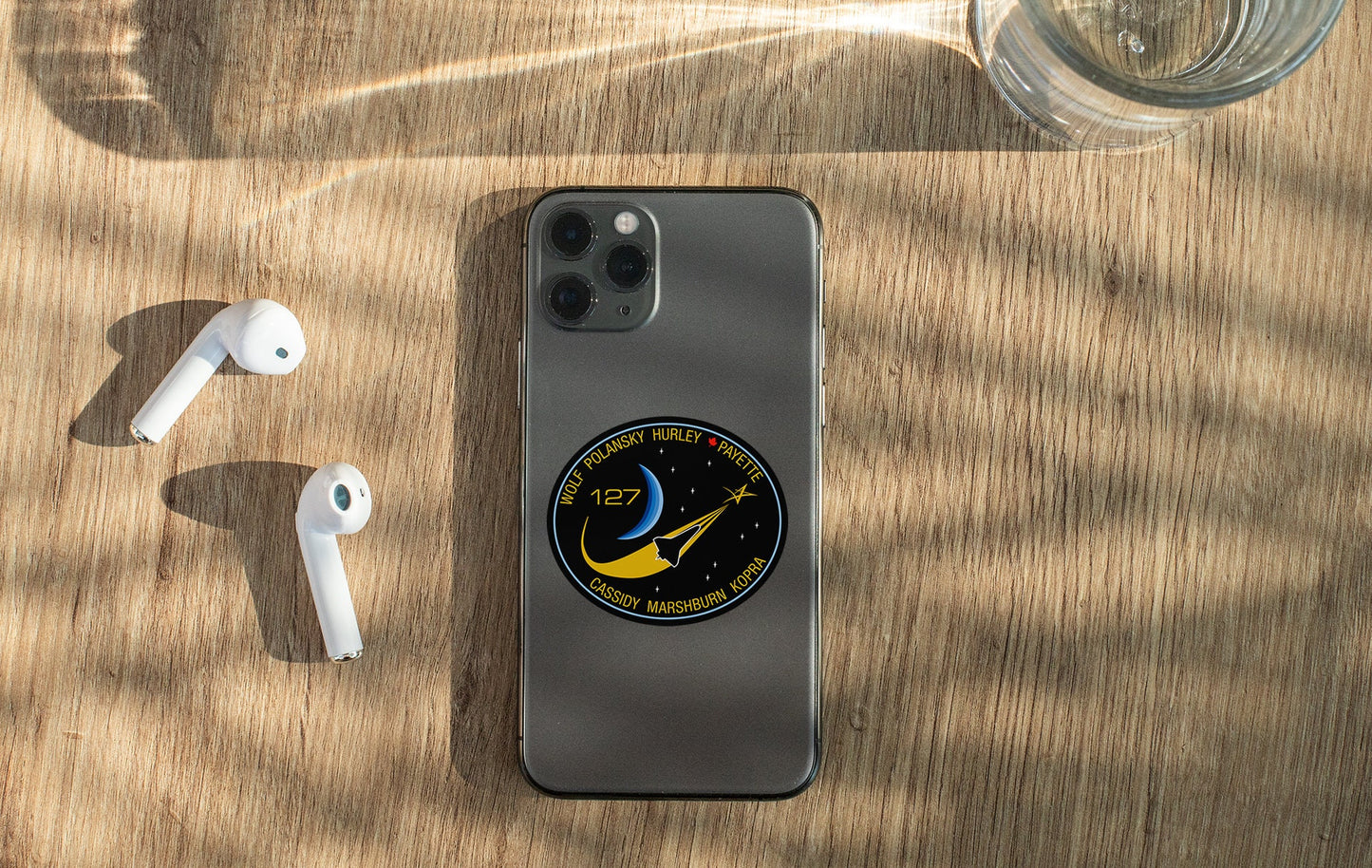 a phone and ear buds sitting on a table