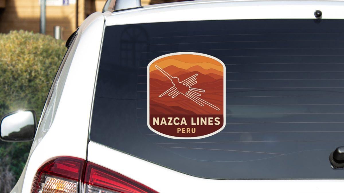 a sticker on the rear window of a white car that says " Nazca Lines Peru".