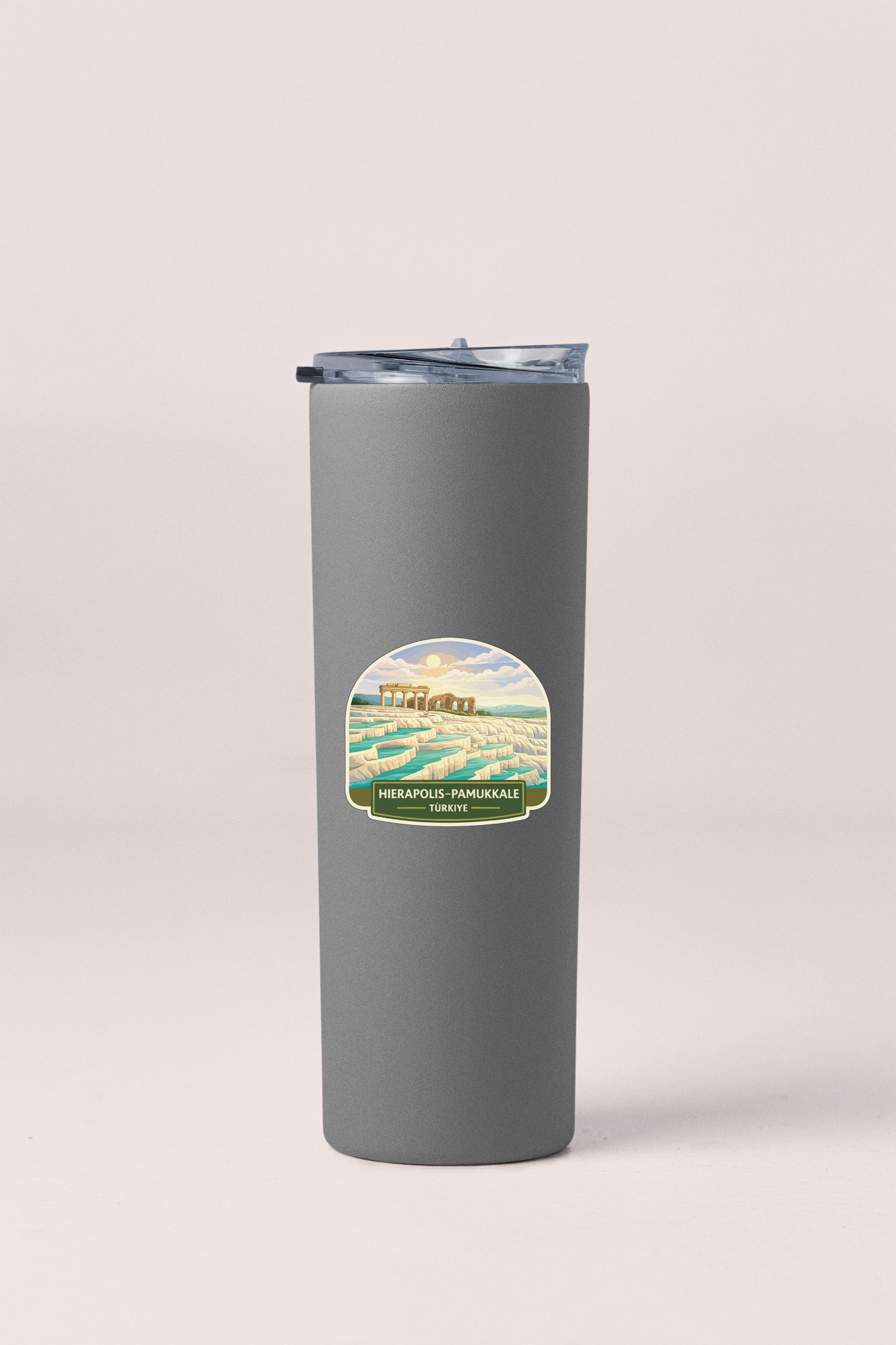 A gray insulated tumbler with a label featuring a scenic landscape.