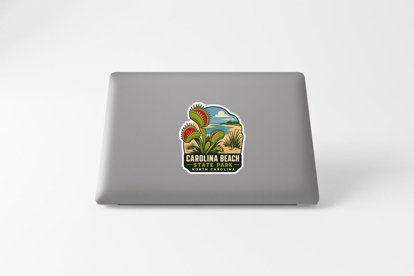 a sticker with a graphic of a carnivorous plant on a laptop.