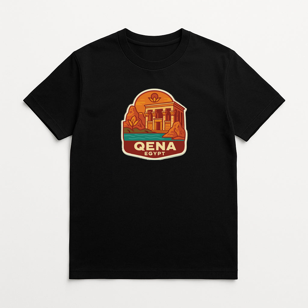 A black t-shirt with a graphic design depicting a temple or building surrounded by a desert landscape, with the text "QENA GAYT" prominently displayed.