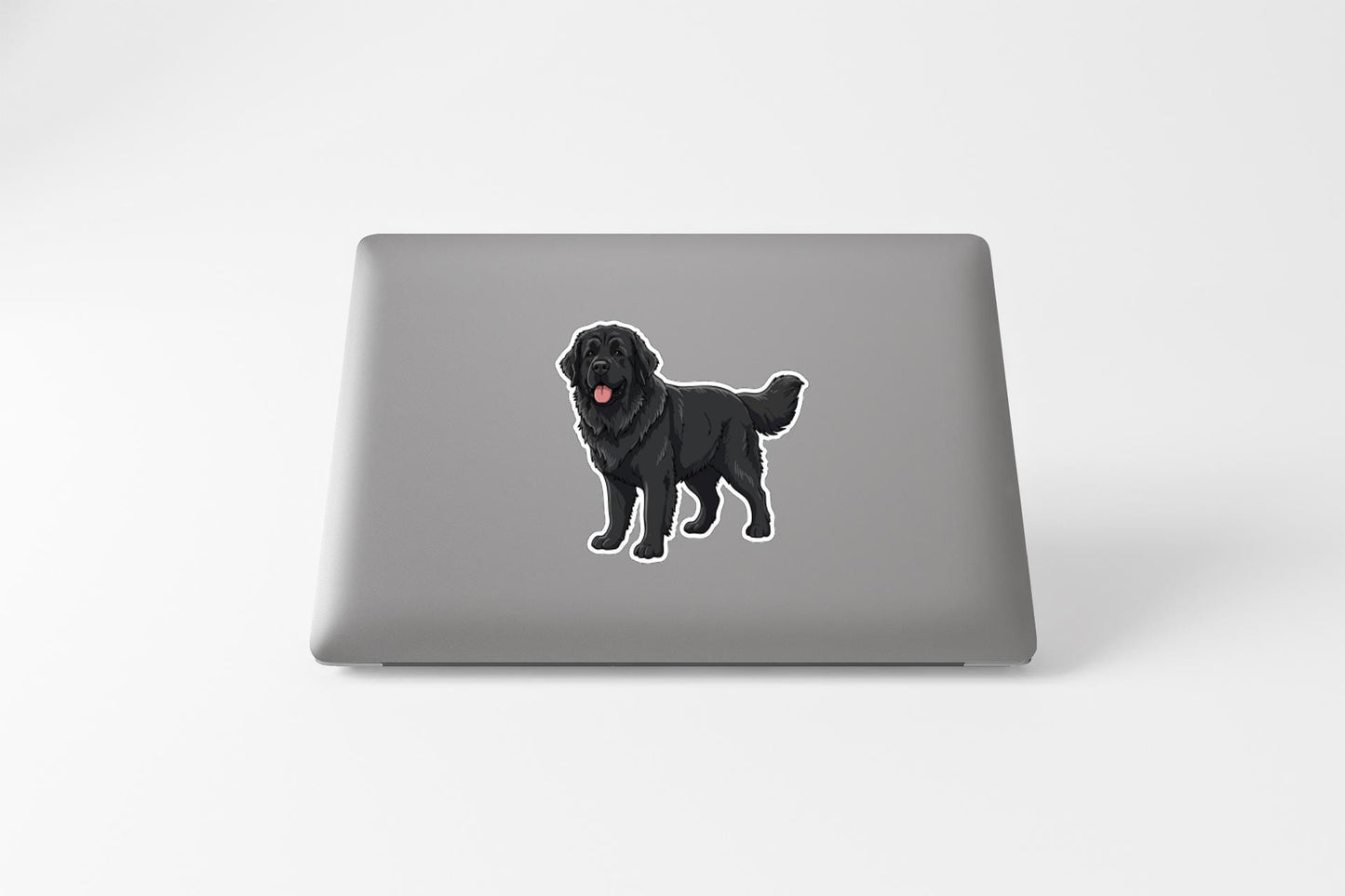 A sticker of a black dog on a laptop.