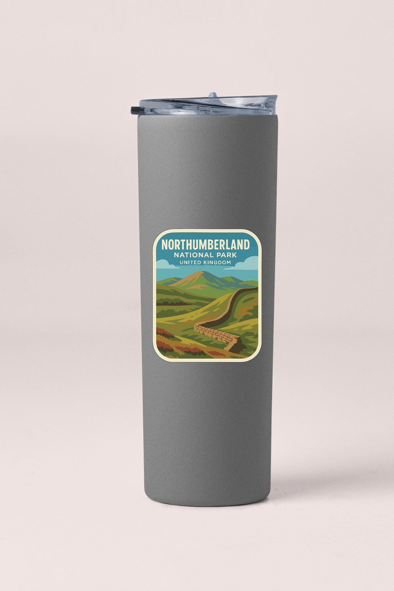 A gray insulated tumbler with a label that says "NORTHUMBERLAND NATIONAL PARK UNITED KINGDOM".