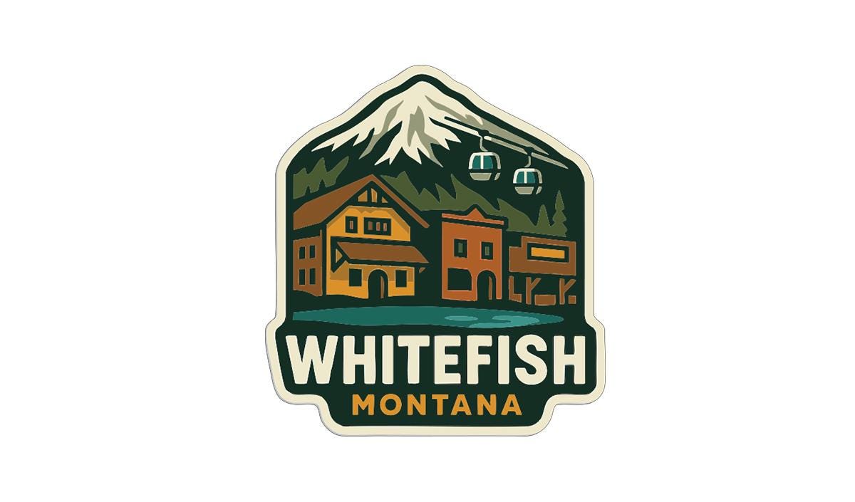 A sticker or logo depicting a mountain landscape with a ski lift, buildings, and a mountain peak, with the text "WHITEFISH MONTANA" prominently displayed.