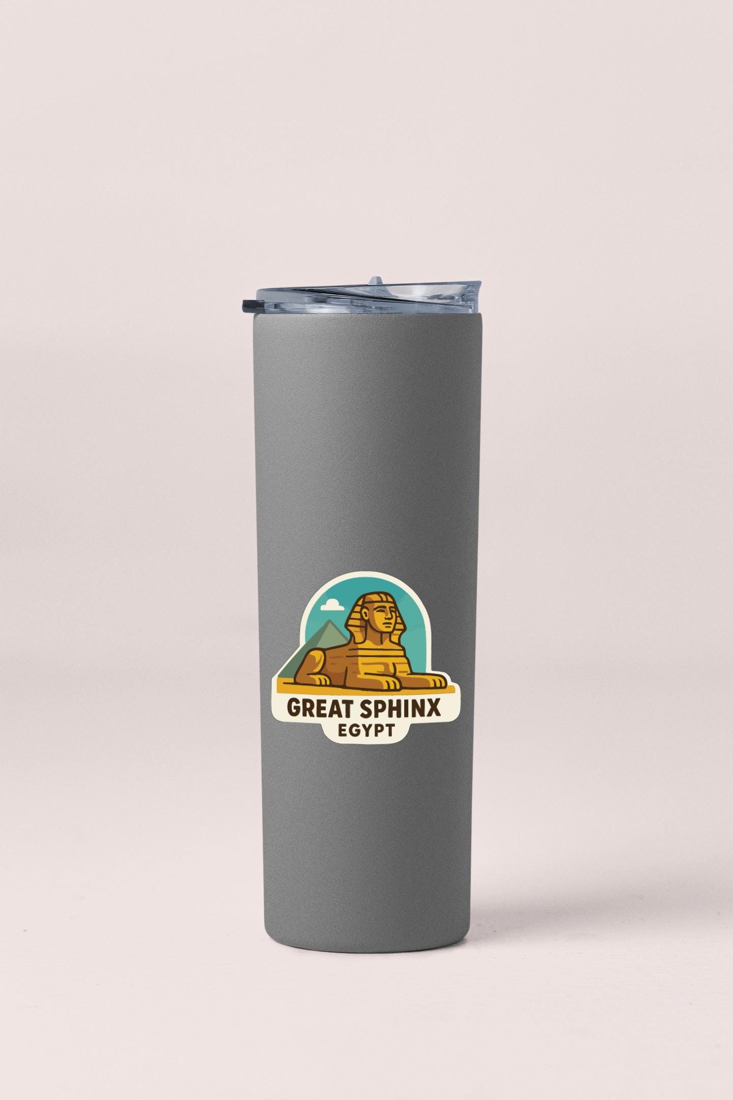 A gray insulated tumbler with a lid and a sticker depicting the Great Sphinx of Giza, a famous landmark in Egypt.