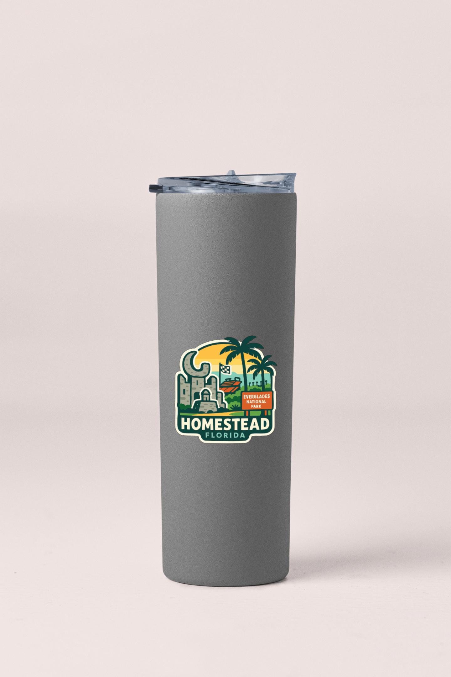 A gray insulated tumbler with a logo that says "HOMESTEAD FLORIDA" printed on it.