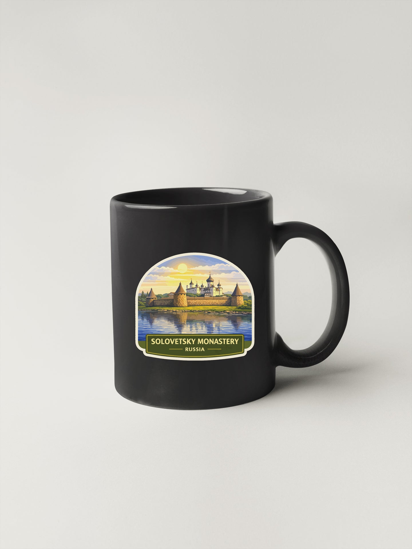 A black coffee mug with a label that says "Solovitsky Monastery Russia".
