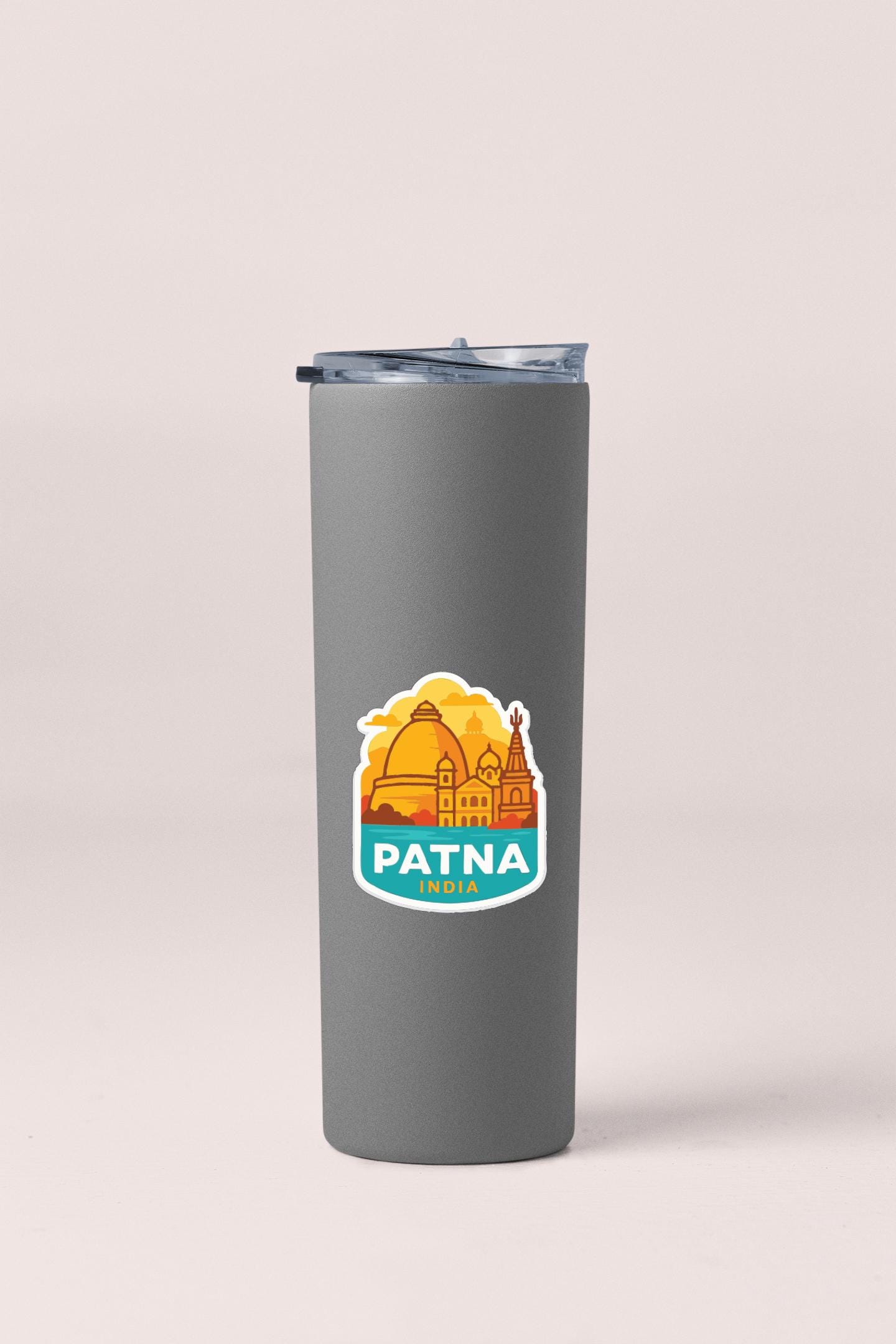 A gray insulated tumbler with a sticker depicting the city of Patna, India.