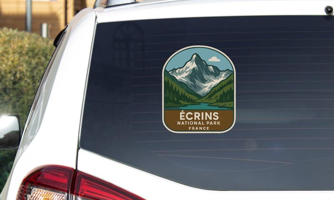 A sticker on the rear window of a car that says "Écrins National Park France".