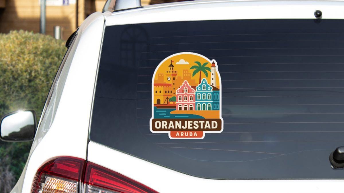 A sticker on the rear window of a car that says "Oranjestad Aruba".