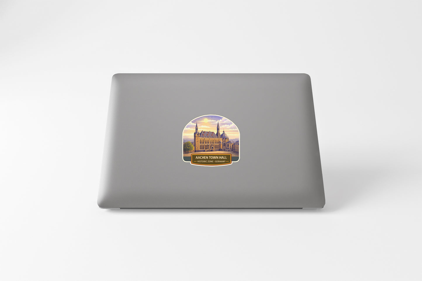 a sticker with a castle on it, placed on the back of a laptop.