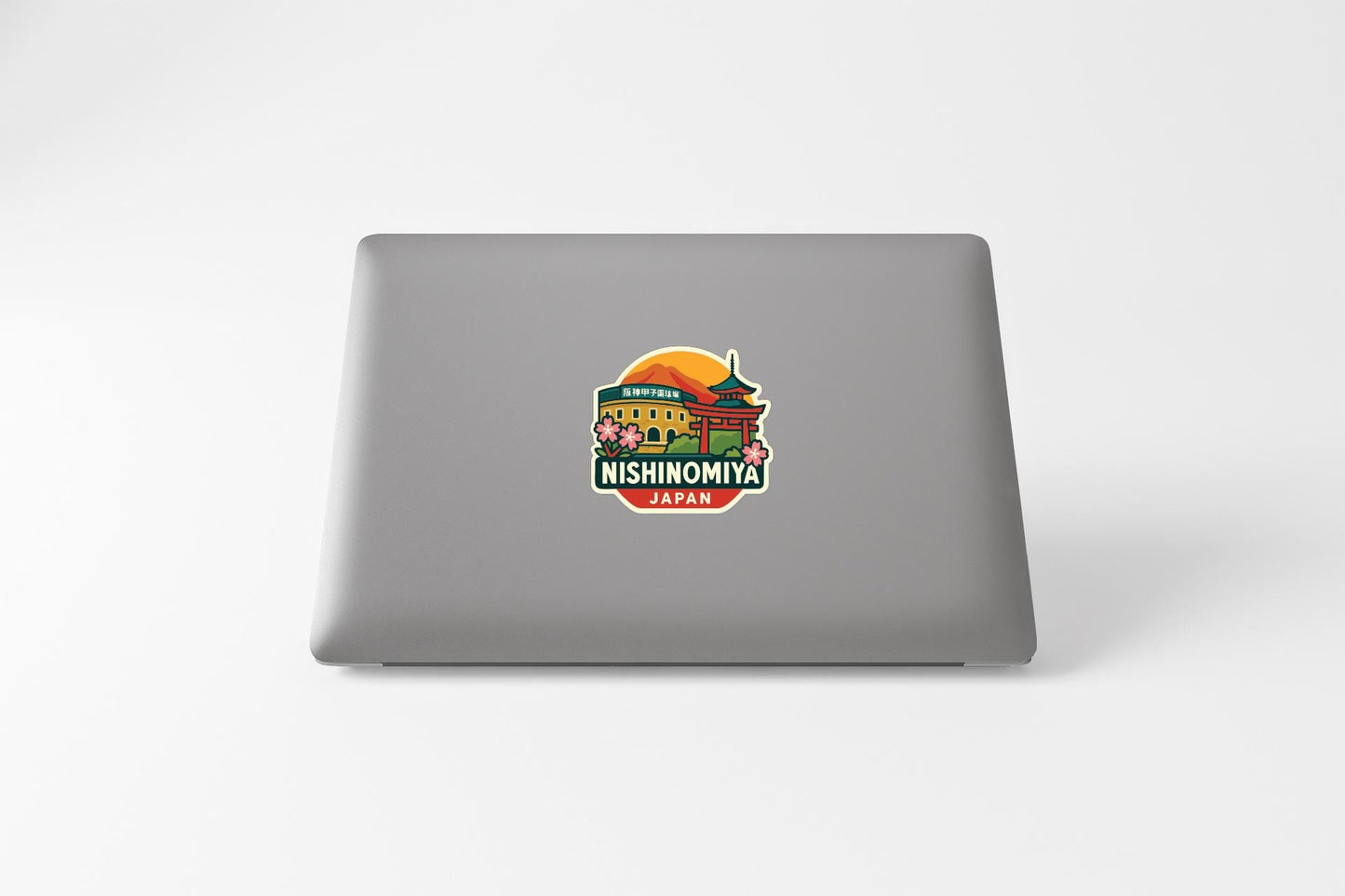 A sticker on the back of a laptop, depicting a temple and the text "NISHINOMIYA JAPAN".
