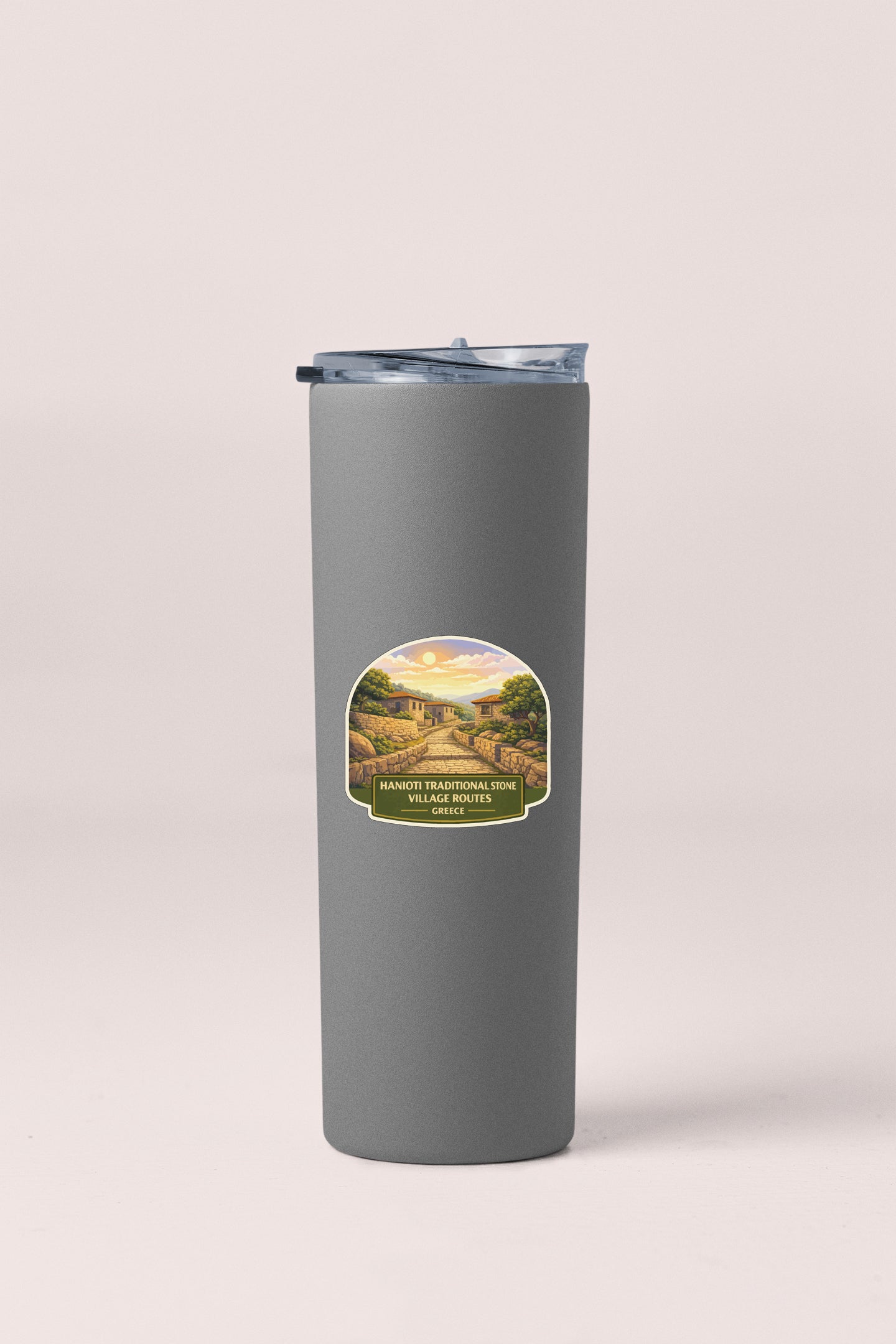 A gray insulated tumbler with a label depicting a scenic landscape.