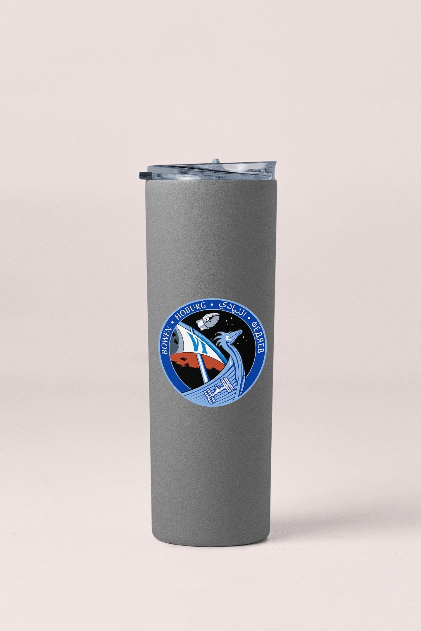 a stainless steel travel mug with a nasa emblem