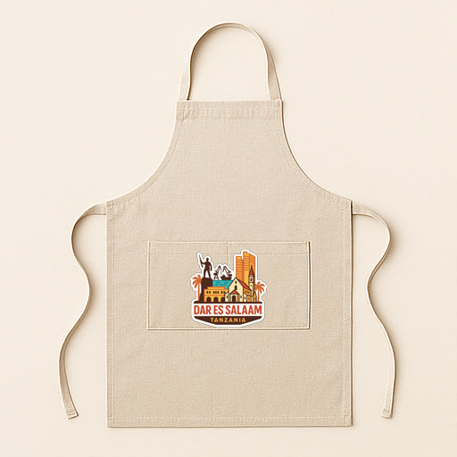 A beige apricot with a graphic design on it, featuring a city skyline and the text "DARES E SALAAM"