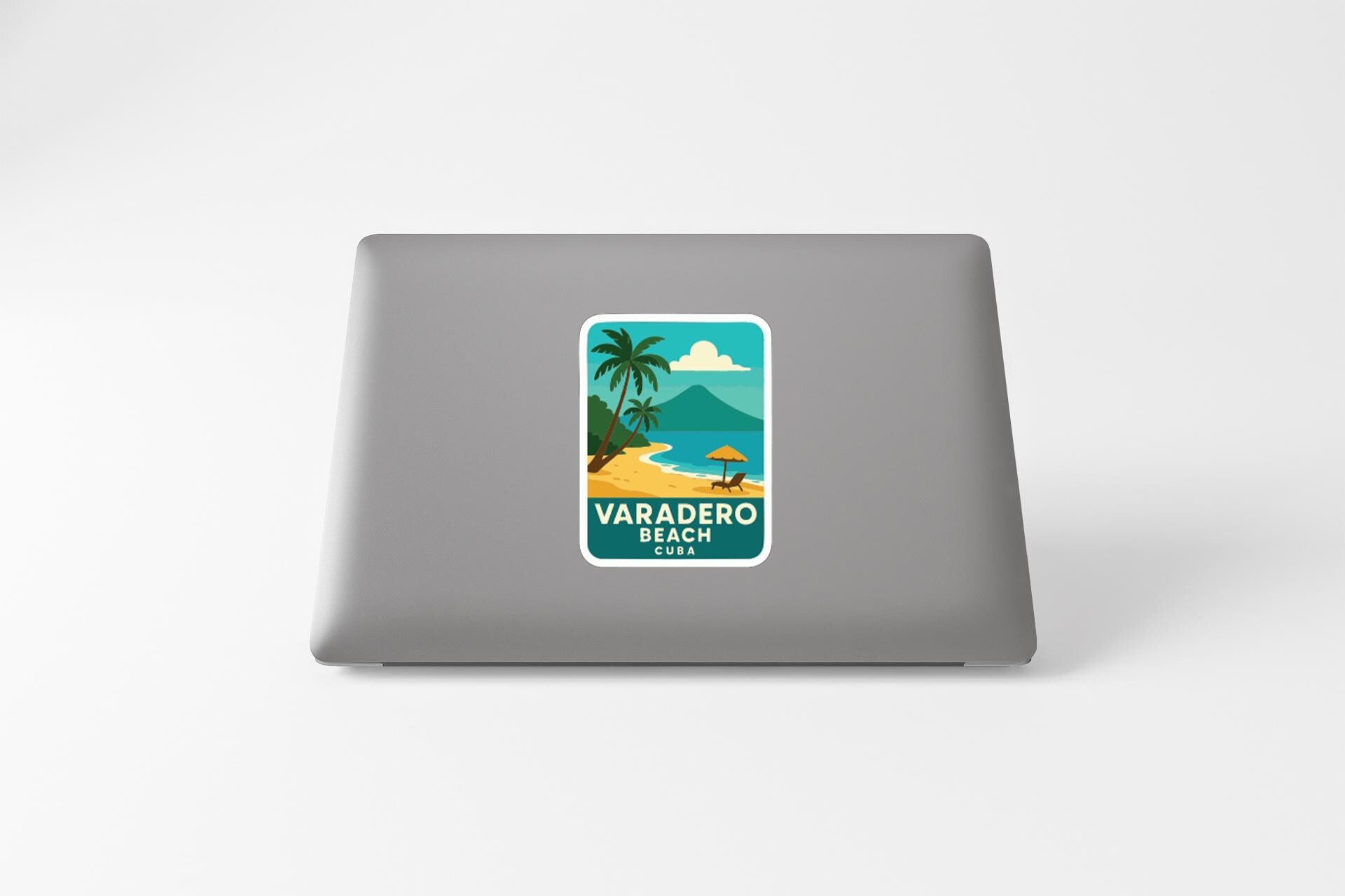 a sticker with a tropical beach scene on a laptop.
