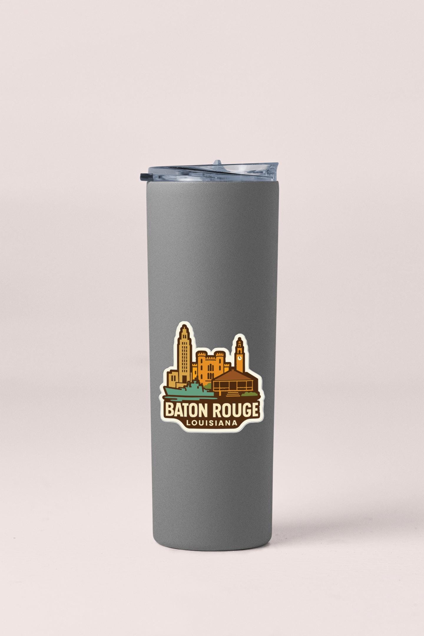 A gray insulated tumbler with a sticker depicting the city of Baton Rouge, Louisiana.